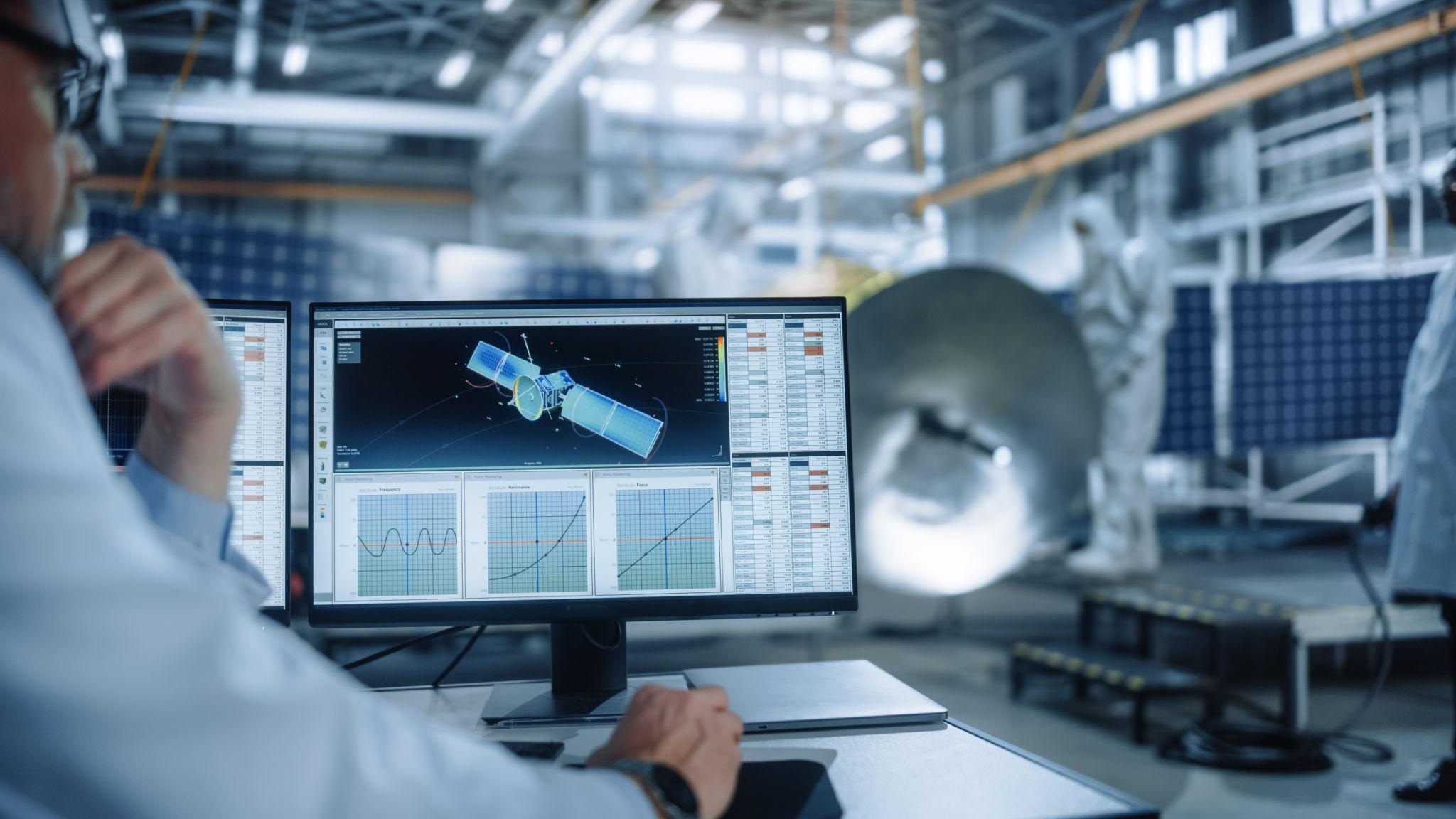 Maxar Technologies satellite engineering and geospatial data analysis on computer screen in space lab